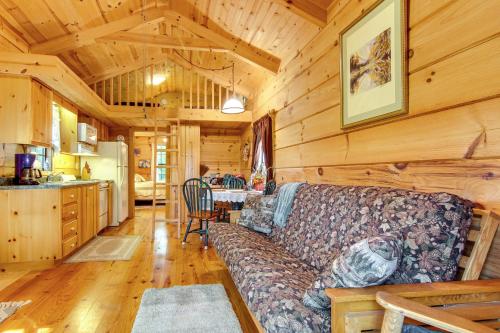 a living room with a couch in a log cabin at Hendersonville Cabin Near Hiking and Waterfalls! in Hendersonville