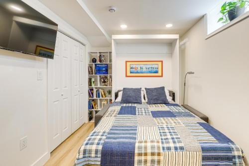 a bedroom with a bed and a book shelf at 7 Mi to National Mall Bright DC Studio! in Washington, D.C.