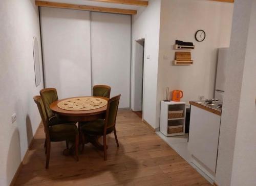 a kitchen with a table and chairs in a room at Rivergreen in Banja Luka