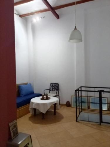 a living room with a blue couch and a bed at Maison Sevilla in Larache