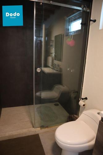 a bathroom with a shower with a toilet and a sink at Casa en Mazatlan con alberca privada en centro historico in Mazatlán