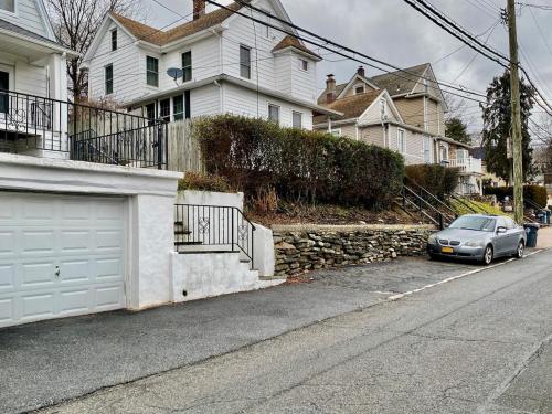 a car parked on the side of a street with houses at Hartsdale Escape Cozy Studio With Patio in Hartsdale