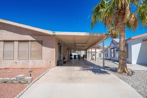a building with a palm tree next to a sidewalk at Buckskin Tango, Views! in Parker
