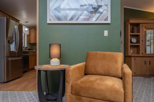 a living room with a chair and a table at Buckskin Tango, Views! in Parker