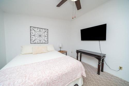 a bedroom with a bed and a flat screen tv at Buckskin Tango, Views! in Parker