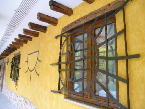 a yellow building with a window with aigil on it at Hostal Xaloa Orio in Orio