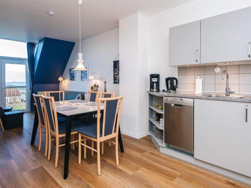 a kitchen and dining room with a table and chairs at 4 person holiday home in Hejls-By Traum in Hejls