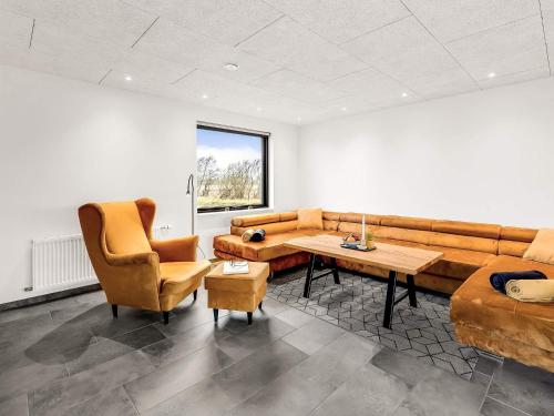 a living room with a couch and a table and chairs at 4 star holiday home in Ulfborg-By Traum in Ulfborg
