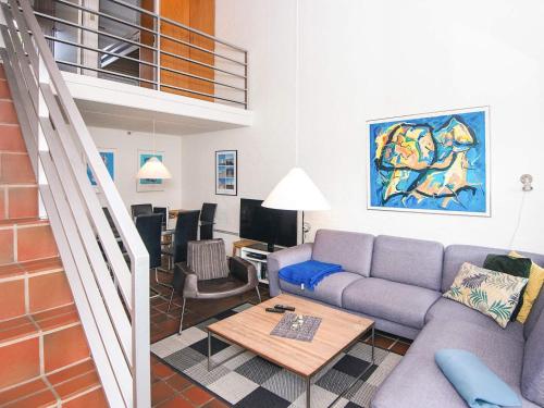 a living room with a couch and a table at 6 person holiday home in Blåvand-By Traum in Blåvand