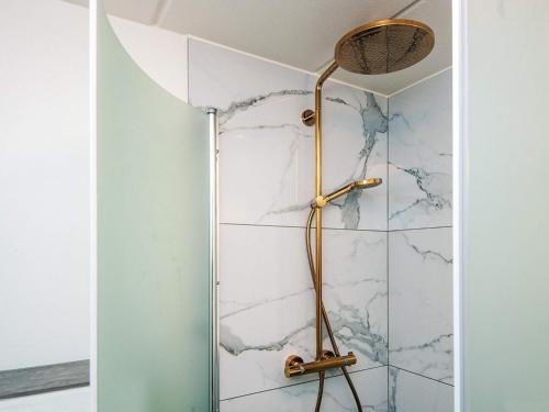 a shower in a bathroom with white marble at 6 person holiday home in Blåvand-By Traum in Blåvand
