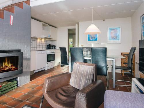a living room with a couch and a fireplace at 6 person holiday home in Blåvand-By Traum in Blåvand