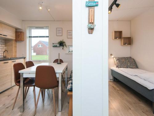 a kitchen and a living room with a table and chairs at 4 star holiday home in Rømø-By Traum in Sønderby
