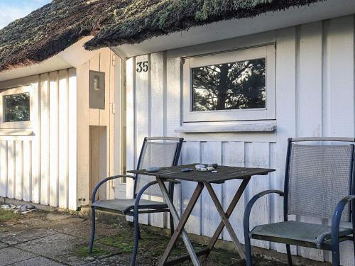 a table and two chairs in front of a house at 8 person holiday home in Fjerritslev-By Traum in Fjerritslev