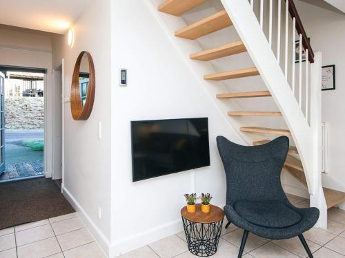 a living room with a chair and a tv at 8 person holiday home in Gjern in Gjern