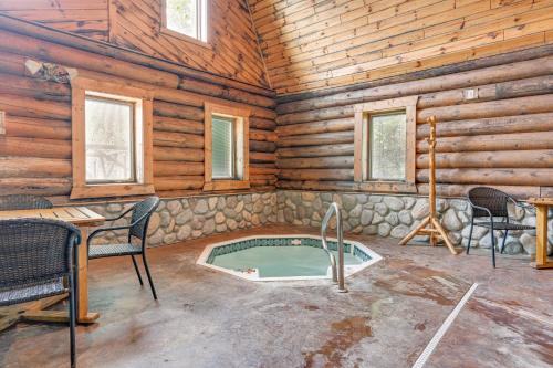 a room with a hot tub in a log cabin at Spacious Sterling Cabin Game Room, Private Pond! in Sterling