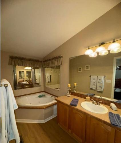 a large bathroom with a tub and a sink at Cliff Hanger, River access with dock in Parker