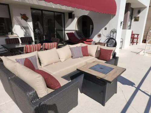a wicker couch and a table on a patio at Kastle on the Keys, private dock in Parker