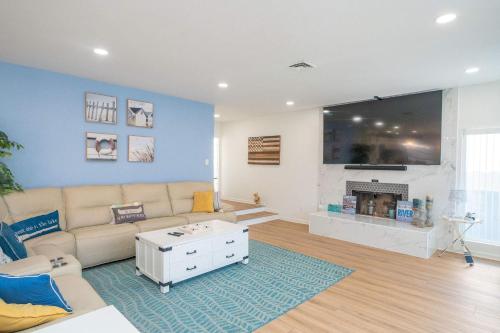a living room with a couch and a fireplace at Ohana Beach, Paradise Escape in Parker
