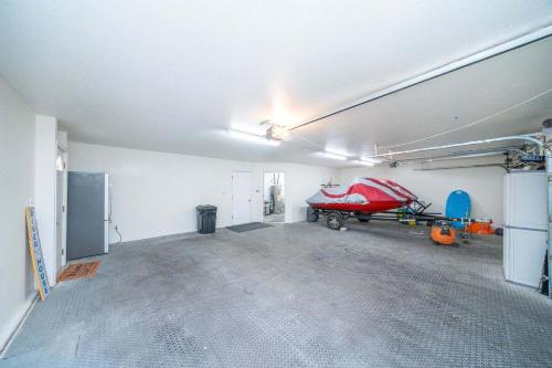 an empty garage with a red motorcycle parked in it at Ohana Beach, Paradise Escape in Parker