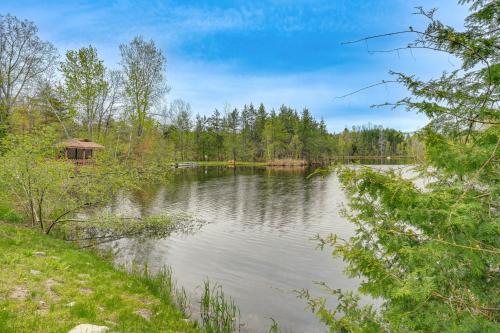 a view of a lake with a gazebo at Spacious Sterling Cabin Game Room, Private Pond! in Sterling