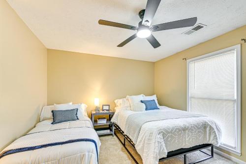 two beds in a bedroom with a ceiling fan at Family Home with Ping-Pong and Fire Pit in Lexington in Lexington