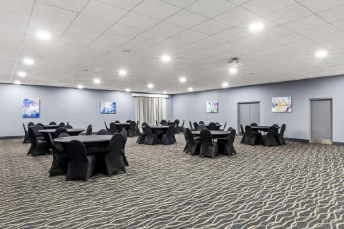 a room with black tables and chairs in it at Best Western Atlanta Cumberland Galleria Hotel in Atlanta