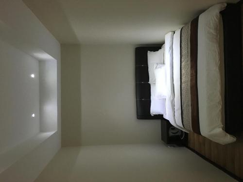 a room with white towels hanging on a wall at Qu Lin Resident in Sibu