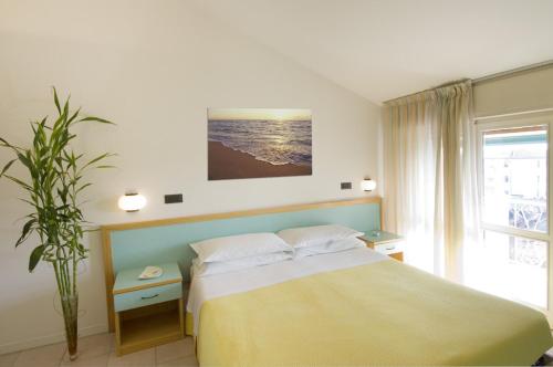 a bedroom with a large bed and a window at Villa Greta in Santarcangelo di Romagna