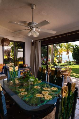 a dining room with a table with food on it at Casa Bonita and villas in Isla Mujeres