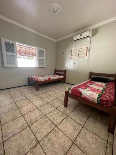 Ένα ή περισσότερα κρεβάτια σε δωμάτιο στο Casa Iguape