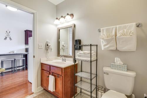 a bathroom with a sink and a toilet and a mirror at Smith Mountain Lake Condo with Pool Access in Huddleston