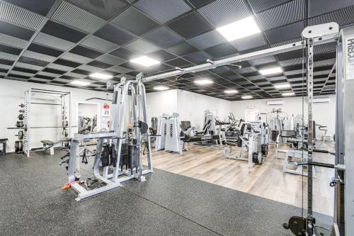 a gym with treadmills and machines in a room at Smith Mountain Lake Condo with Pool Access in Huddleston