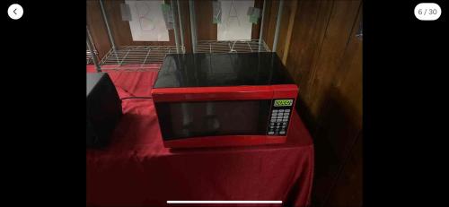 a red microwave sitting on top of a red table at Tarawa drive in Cincinnati