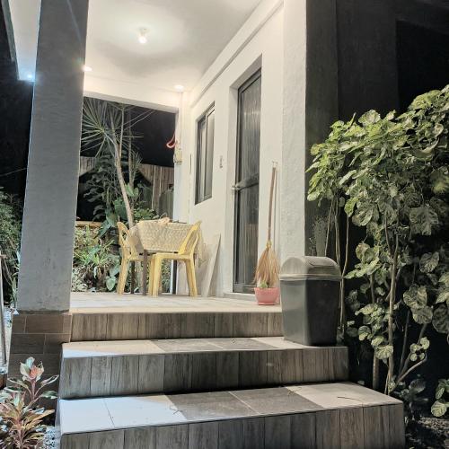 a house with stairs and a chair on the porch at Villa catalina Bora 2 Resort in Nabas