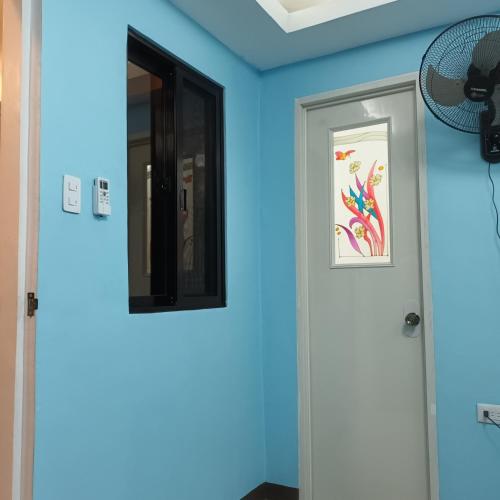 two doors in a room with blue walls at Villa catalina Bora 2 Resort in Nabas
