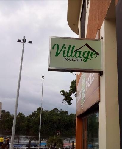 a sign on the side of a building at Pousada Village in Barreirinhas