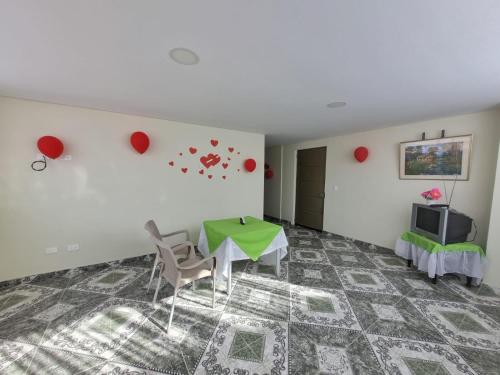 a room with a table and chairs and a television at Edificio K&C in Sogamoso