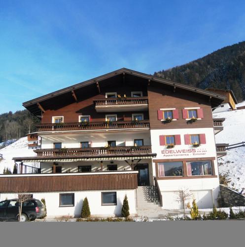 a large building with snow on the ground at Edelweiss am See in Zell am See