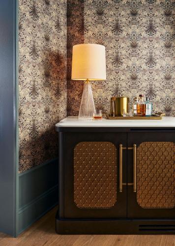 a table with a lamp on top of a cabinet at Fidelity Hotel in Cleveland