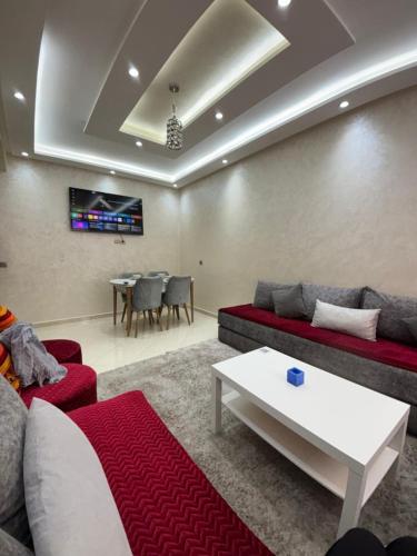 a living room with a couch and a table at Jardins Anass 3 Aéroport Marrakech in Marrakech