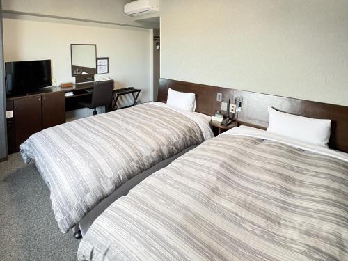 Postel nebo postele na pokoji v ubytování Hotel Route-Inn Shimodate