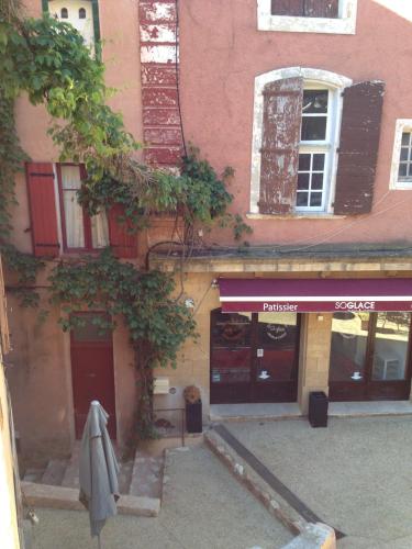 a building with a umbrella in front of it at Roussillon House in Roussillon