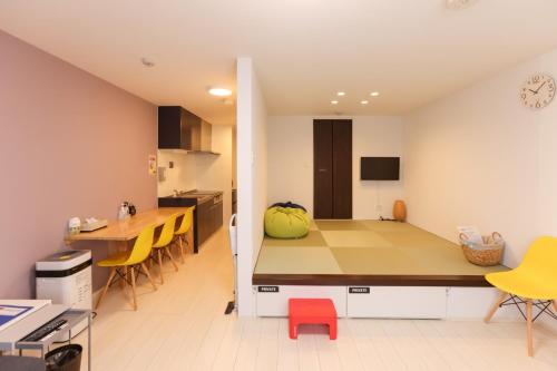 a kitchen and dining room with a table and yellow chairs at Guest House Gifuhashima COCONE / Vacation STAY 33937 in Hashima
