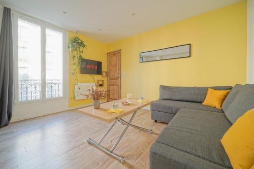 un salon avec un canapé et une table dans l'établissement Ravissant cocon moderne - proche Stade de France, à Saint-Denis