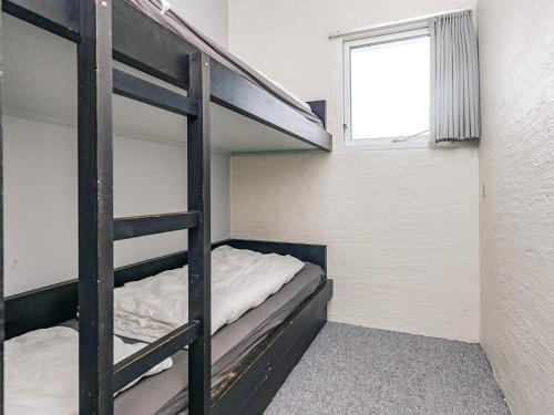 a bunk bed room with two bunk beds and a window at 6 person holiday home in Brovst in Brovst