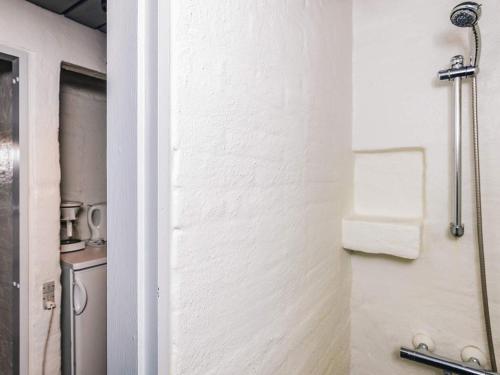 a bathroom with a towel rack on a wall at 6 person holiday home in Brovst in Brovst