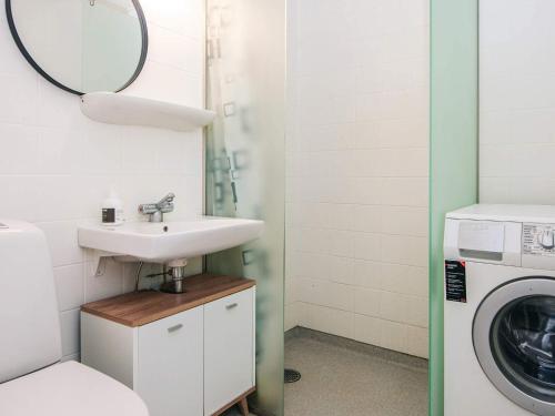 a bathroom with a sink and a washing machine at 6 person holiday home in Ringkøbing in Ringkøbing
