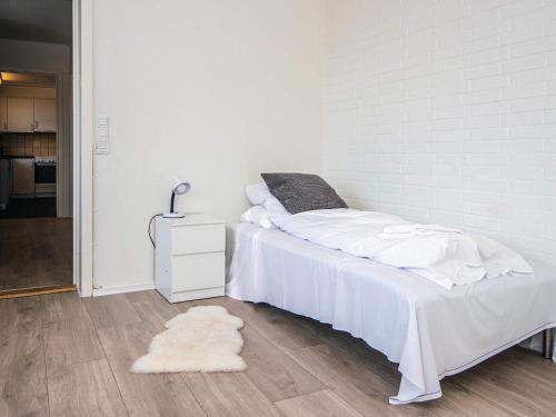 a white bedroom with a bed and a rug at 6 person holiday home in Ringkøbing in Ringkøbing