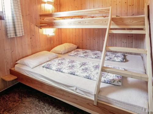 two bunk beds in a cabin with a ladder at 4 person holiday home in Risør in Risør