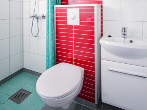 a bathroom with a white toilet and a sink at 4 person holiday home in Risør in Risør